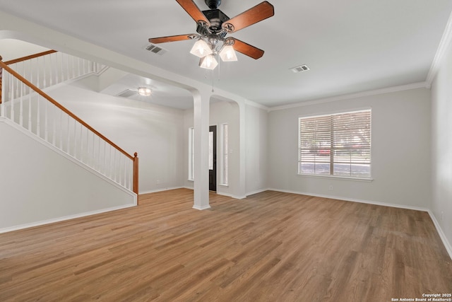 17223 Darlington Run, San Antonio, TX 78247 - unfurnished living room featuring arched walkways, a ceiling fan, wood finished floors, baseboards, and stairway