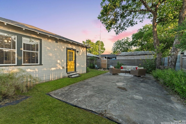 631 Muncey St, San Antonio, TX 78202 - patio terrace at dusk featuring an outdoor living space, entry steps, and a fenced backyard