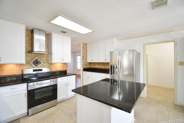 15850 Marisa Pl, San Antonio, TX 78247 - kitchen featuring appliances with stainless steel finishes, wall chimney range hood, tasteful backsplash, white cabinets, and a textured ceiling