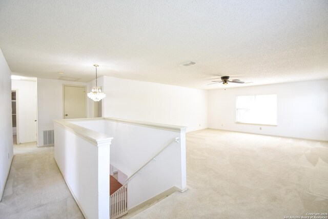15850 Marisa Pl, San Antonio, TX 78247 - corridor with an upstairs landing, light carpet, a textured ceiling, and a chandelier