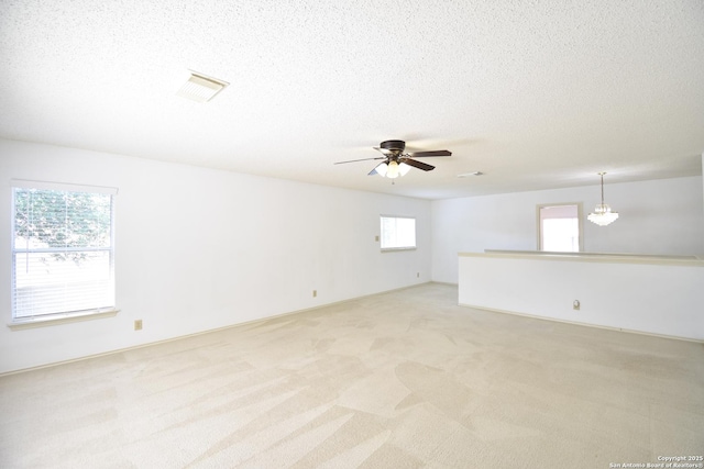 15850 Marisa Pl, San Antonio, TX 78247 - empty room with ceiling fan, light carpet, and a textured ceiling