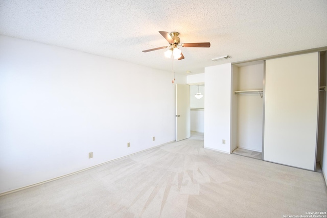 15850 Marisa Pl, San Antonio, TX 78247 - unfurnished bedroom featuring a closet, a textured ceiling, light carpet, and ceiling fan