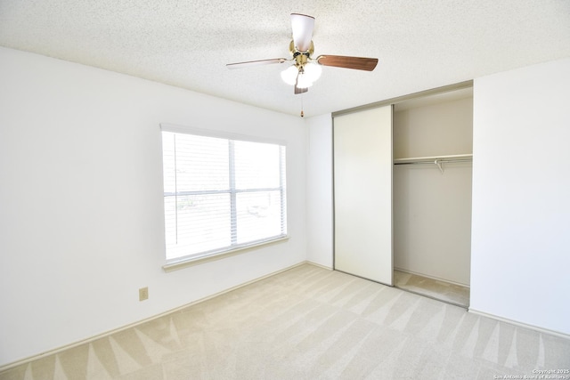15850 Marisa Pl, San Antonio, TX 78247 - unfurnished bedroom with light colored carpet, a closet, a ceiling fan, and a textured ceiling