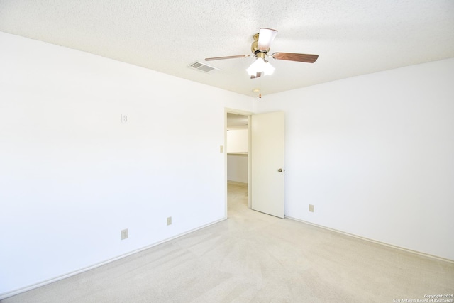 15850 Marisa Pl, San Antonio, TX 78247 - empty room featuring light colored carpet, ceiling fan, and a textured ceiling