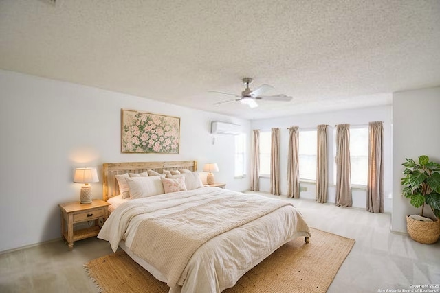 15850 Marisa Pl, San Antonio, TX 78247 - bedroom featuring a wall mounted air conditioner, light colored carpet, a textured ceiling, and ceiling fan