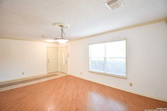 15850 Marisa Pl, San Antonio, TX 78247 - unfurnished room with a textured ceiling, light wood finished floors, crown molding, and baseboards