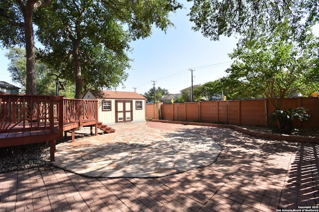 15850 Marisa Pl, San Antonio, TX 78247 - wooden deck with a fenced backyard, an outbuilding, a storage shed, and a patio area