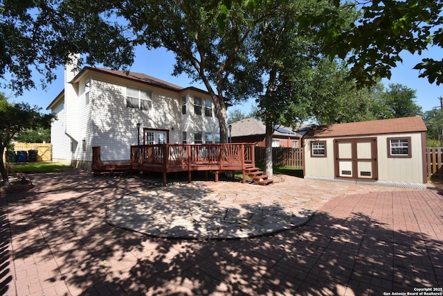 15850 Marisa Pl, San Antonio, TX 78247 - rear view of property featuring a deck, fence, a patio, an outbuilding, and a chimney