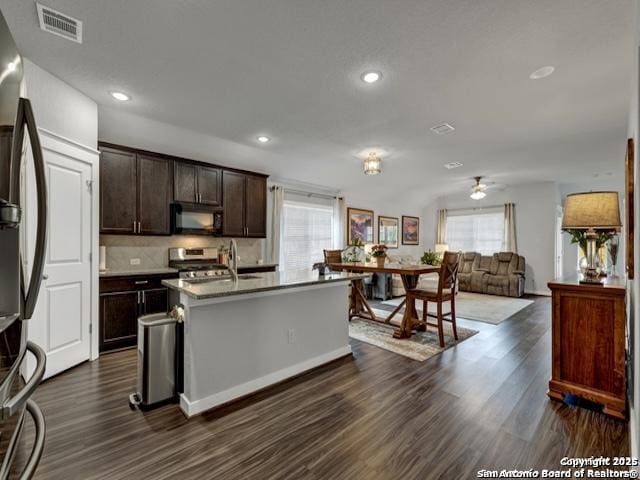4047 Legend Mdws, New Braunfels, TX 78130 - kitchen featuring stainless steel appliances, plenty of natural light, dark brown cabinetry, dark wood-type flooring, and recessed lighting