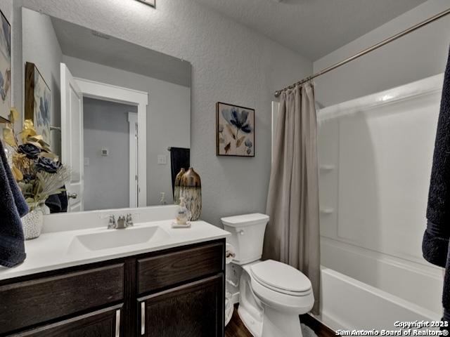 4047 Legend Mdws, New Braunfels, TX 78130 - full bath featuring toilet, vanity, shower / tub combo, and wood finished floors