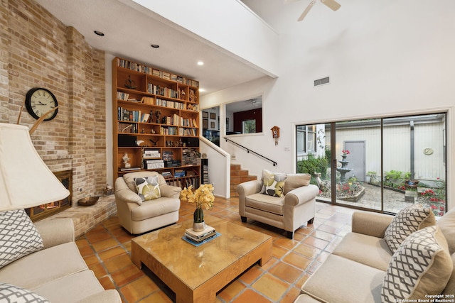 11400 Mission Trce, San Antonio, TX 78230 - tiled living area featuring stairway, ceiling fan, a brick fireplace, a high ceiling, and recessed lighting
