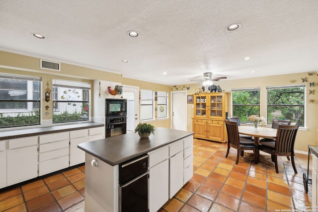 11400 Mission Trce, San Antonio, TX 78230 - kitchen featuring black appliances, dark countertops, a textured ceiling, recessed lighting, and white cabinetry
