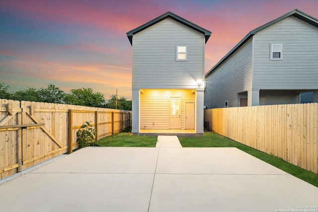 503 Linden, San Antonio, TX 78211 - back of property at dusk with a patio area and a fenced backyard