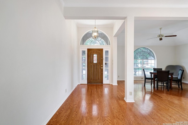 4635 Shavano Birch, San Antonio, TX 78230 - foyer entrance featuring wood finished floors, a chandelier, ceiling fan, baseboards, and crown molding