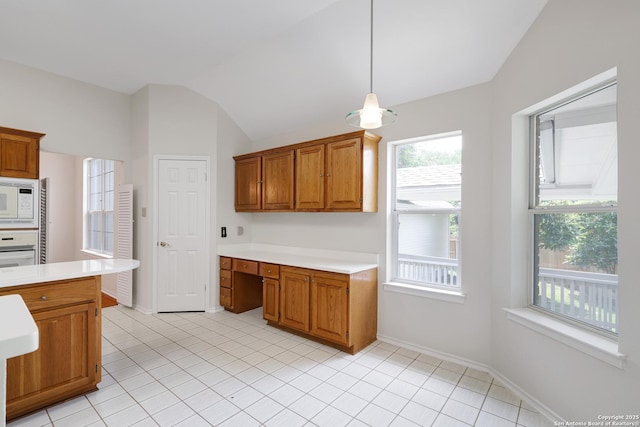 4635 Shavano Birch, San Antonio, TX 78230 - kitchen with white appliances, light countertops, brown cabinetry, lofted ceiling, and light tile patterned floors