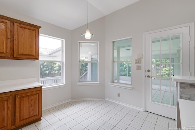 4635 Shavano Birch, San Antonio, TX 78230 - unfurnished dining area featuring baseboards, light tile patterned floors, and lofted ceiling