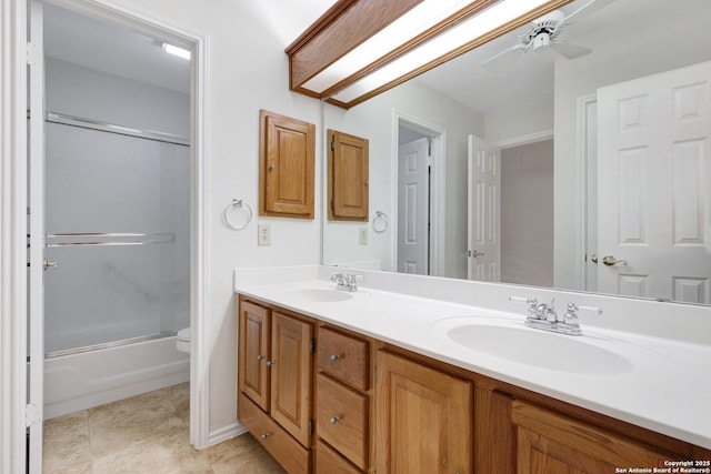 4635 Shavano Birch, San Antonio, TX 78230 - bathroom with double vanity, ceiling fan, bath / shower combo with glass door, toilet, and tile patterned flooring