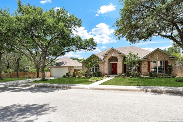 4635 Shavano Birch, San Antonio, TX 78230 - view of front of house with brick siding, roof with shingles, and a garage