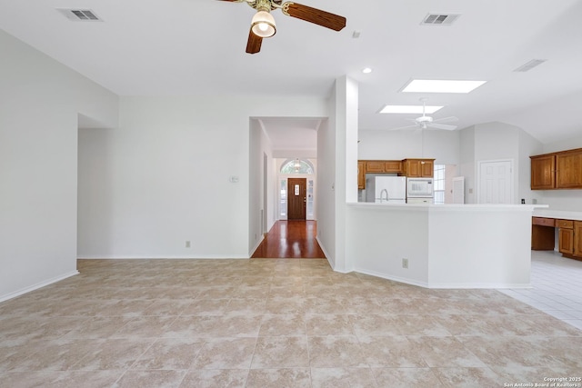 4635 Shavano Birch, San Antonio, TX 78230 - unfurnished living room featuring ceiling fan, light tile patterned flooring, baseboards, and vaulted ceiling