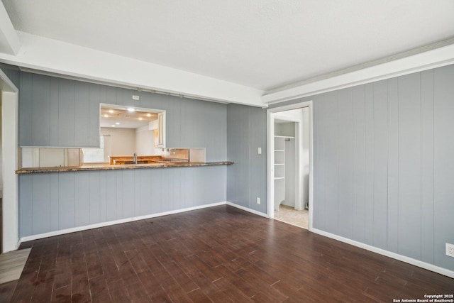 427 Indigo, San Antonio, TX 78216 - unfurnished living room featuring wood finished floors, baseboards, and wood walls
