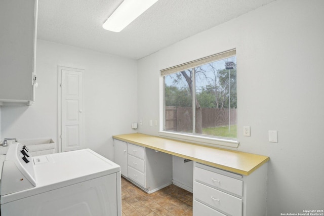 427 Indigo, San Antonio, TX 78216 - washroom with washer and clothes dryer, an office area, a textured ceiling, and cabinet space