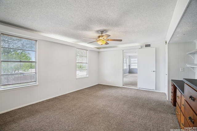 427 Indigo, San Antonio, TX 78216 - empty room with ceiling fan, carpet, a textured ceiling, and baseboards