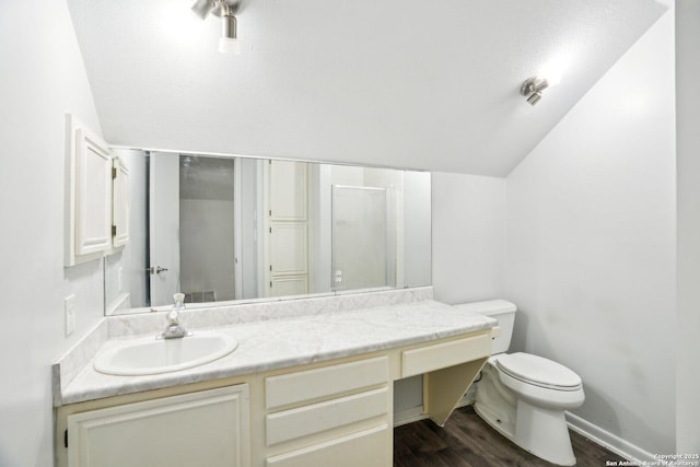 427 Indigo, San Antonio, TX 78216 - bathroom featuring toilet, vaulted ceiling, wood finished floors, vanity, and a shower with shower door