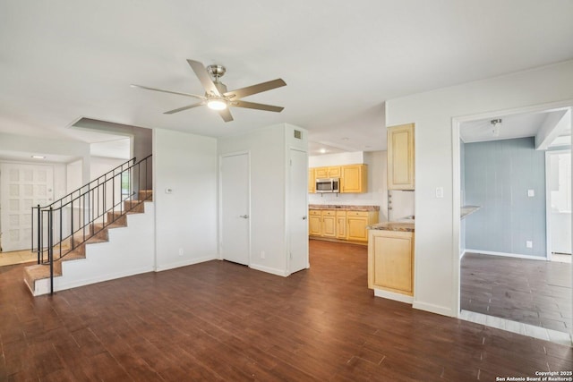 427 Indigo, San Antonio, TX 78216 - unfurnished living room featuring dark wood-type flooring, baseboards, a ceiling fan, and stairway