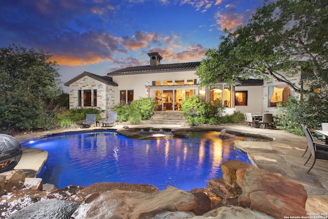 2219 Clubs Dr, Boerne, TX 78006 - pool at dusk with an outdoor pool, a hot tub, a patio area, and outdoor dining space