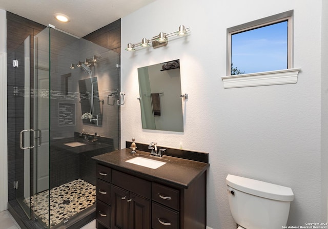 2219 Clubs Dr, Boerne, TX 78006 - bathroom featuring toilet, a shower stall, and vanity
