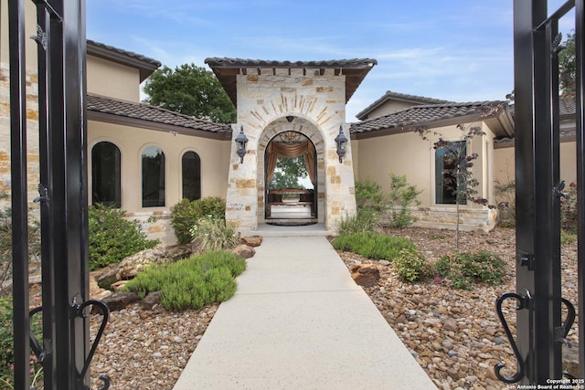 2219 Clubs Dr, Boerne, TX 78006 - entrance to property featuring a tiled roof, stucco siding, and stone siding
