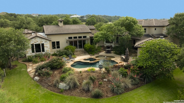 2219 Clubs Dr, Boerne, TX 78006 - back of property featuring stucco siding, a chimney, a tiled roof, a patio area, and a lawn