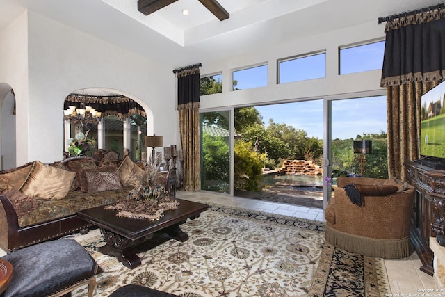 2219 Clubs Dr, Boerne, TX 78006 - living area with arched walkways, a chandelier, tile patterned floors, a towering ceiling, and ceiling fan