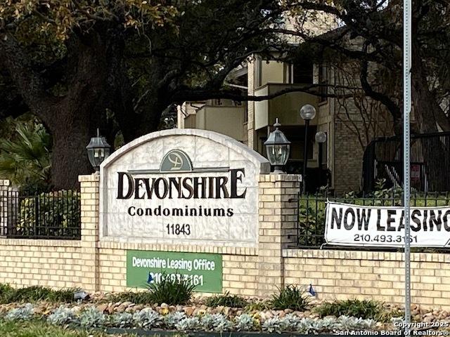 community sign featuring fence
