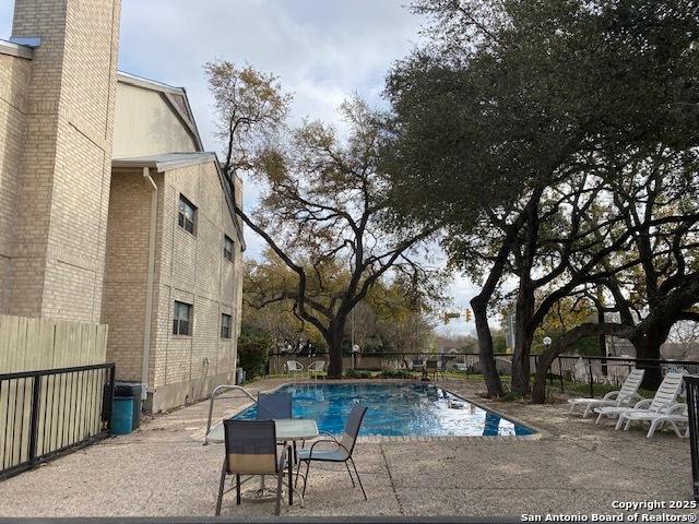 view of pool with fence and a patio area