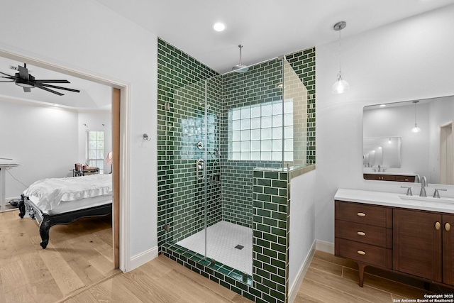 9403 Gardenia Bnd, San Antonio, TX 78266 - bathroom featuring ensuite bathroom, a shower stall, ceiling fan, wood finished floors, and vanity