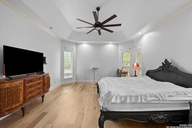 9403 Gardenia Bnd, San Antonio, TX 78266 - bedroom featuring a tray ceiling, light wood-style floors, multiple windows, baseboards, and crown molding
