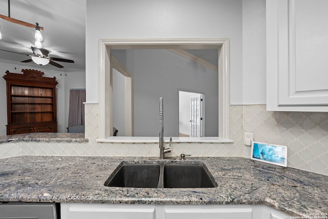 9403 Gardenia Bnd, San Antonio, TX 78266 - kitchen featuring a sink, backsplash, white cabinetry, light stone counters, and crown molding