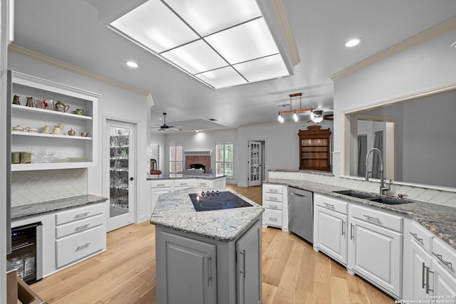 9403 Gardenia Bnd, San Antonio, TX 78266 - kitchen featuring dishwasher, black electric stovetop, a sink, a fireplace, and ornamental molding