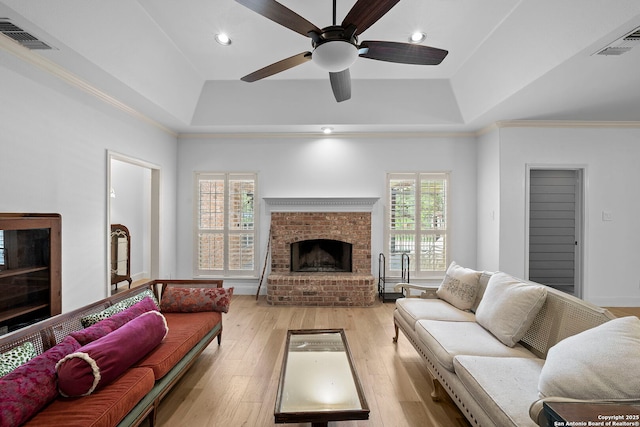 9403 Gardenia Bnd, San Antonio, TX 78266 - living room featuring a raised ceiling, a fireplace, a ceiling fan, recessed lighting, and light wood finished floors