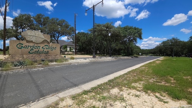 9403 Gardenia Bnd, San Antonio, TX 78266 - view of asphalt road featuring curbs and street lights