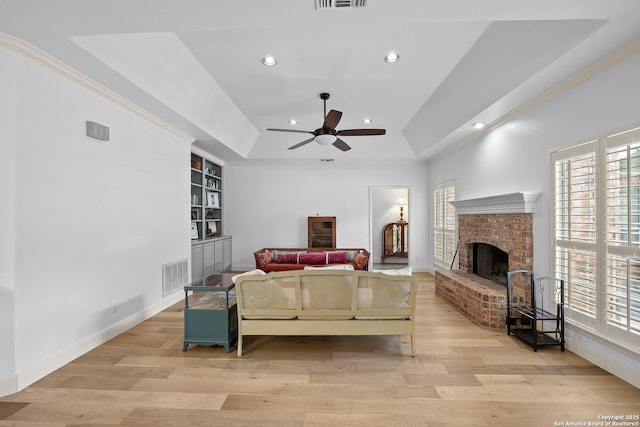 9403 Gardenia Bnd, San Antonio, TX 78266 - living room featuring healthy amount of natural light, a raised ceiling, ceiling fan, recessed lighting, and crown molding