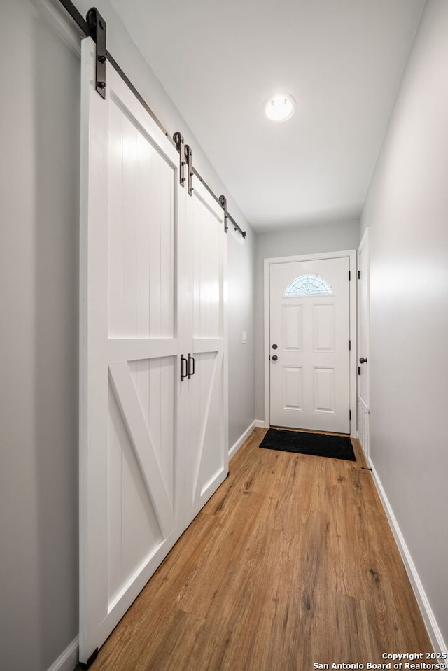 5902 Brambletree, San Antonio, TX 78247 - entryway with a barn door, light wood finished floors, and baseboards