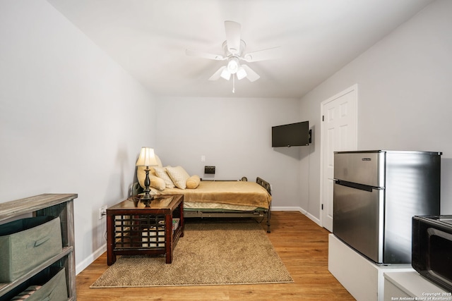 5902 Brambletree, San Antonio, TX 78247 - bedroom with light wood-style floors, freestanding refrigerator, and baseboards