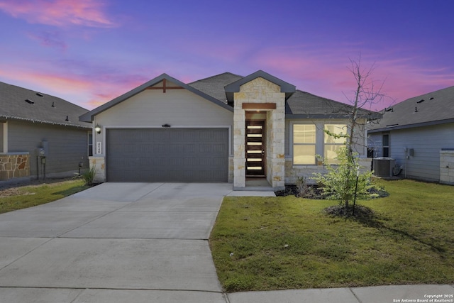 4540 Appaloosa, San Antonio, TX 78245 - view of front of property with stone siding, a garage, concrete driveway, a yard, and central AC