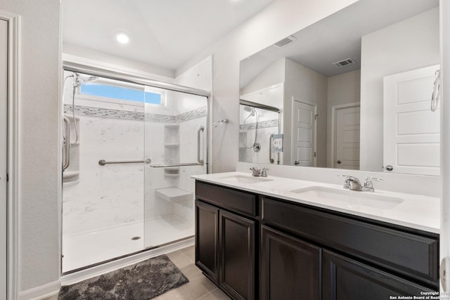 4540 Appaloosa, San Antonio, TX 78245 - bathroom with a stall shower, double vanity, and tile patterned flooring