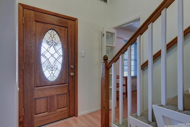 5810 Windvale, Windcrest, TX 78239 - foyer entrance with wood finished floors, stairs, and baseboards