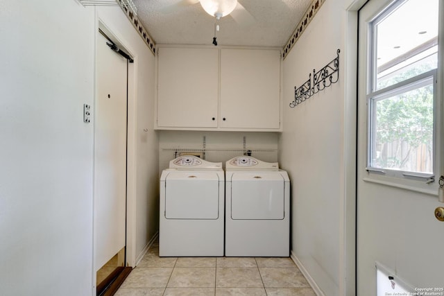 5810 Windvale, Windcrest, TX 78239 - laundry area with cabinet space, washing machine and clothes dryer, plenty of natural light, light tile patterned flooring, and a textured ceiling