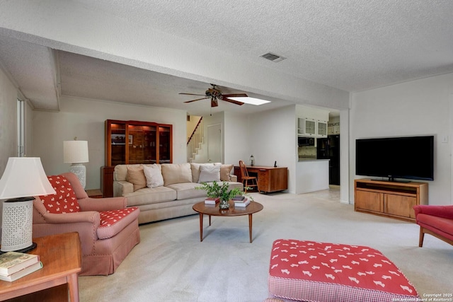 5810 Windvale, Windcrest, TX 78239 - living area featuring stairs, carpet flooring, a textured ceiling, and ceiling fan
