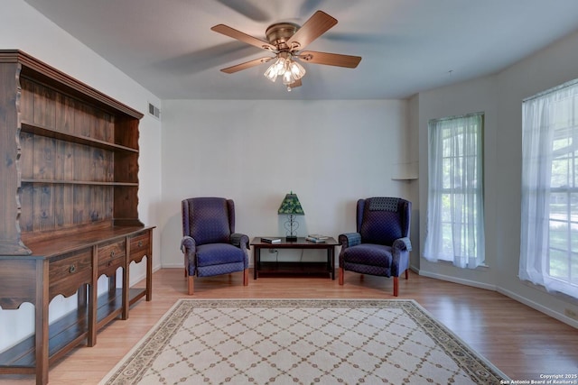 5810 Windvale, Windcrest, TX 78239 - living area with healthy amount of natural light, light wood-style floors, and baseboards